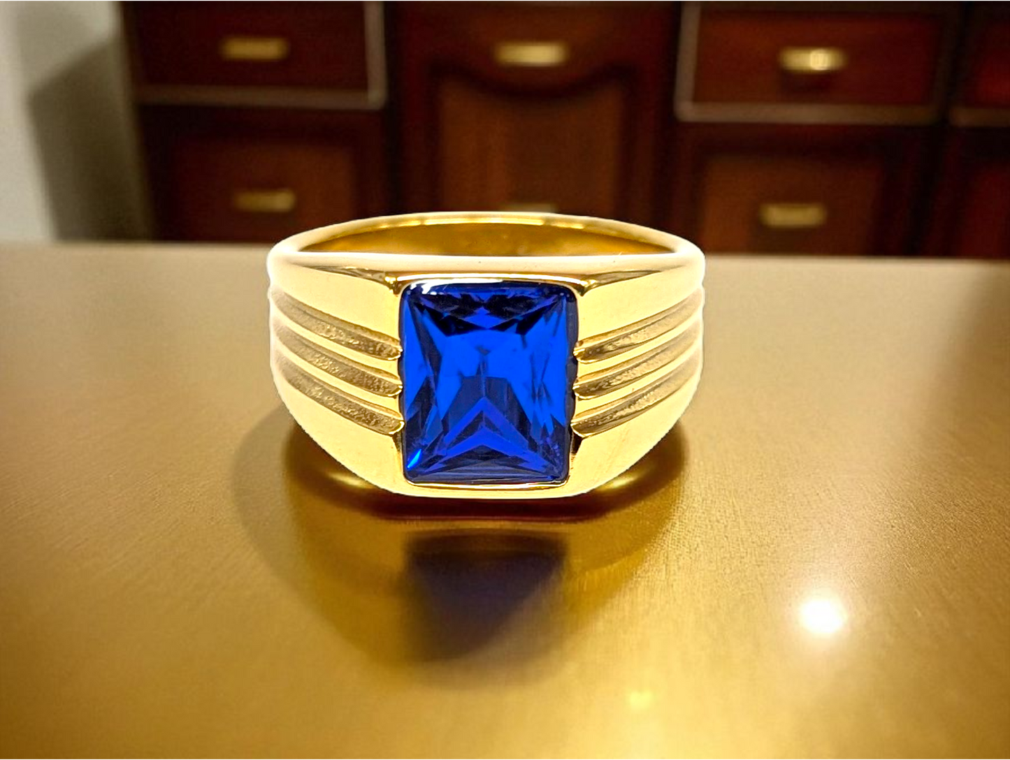 Sapphire Precision: Gold Ring with Square Blue Gemstone & Grooved Band