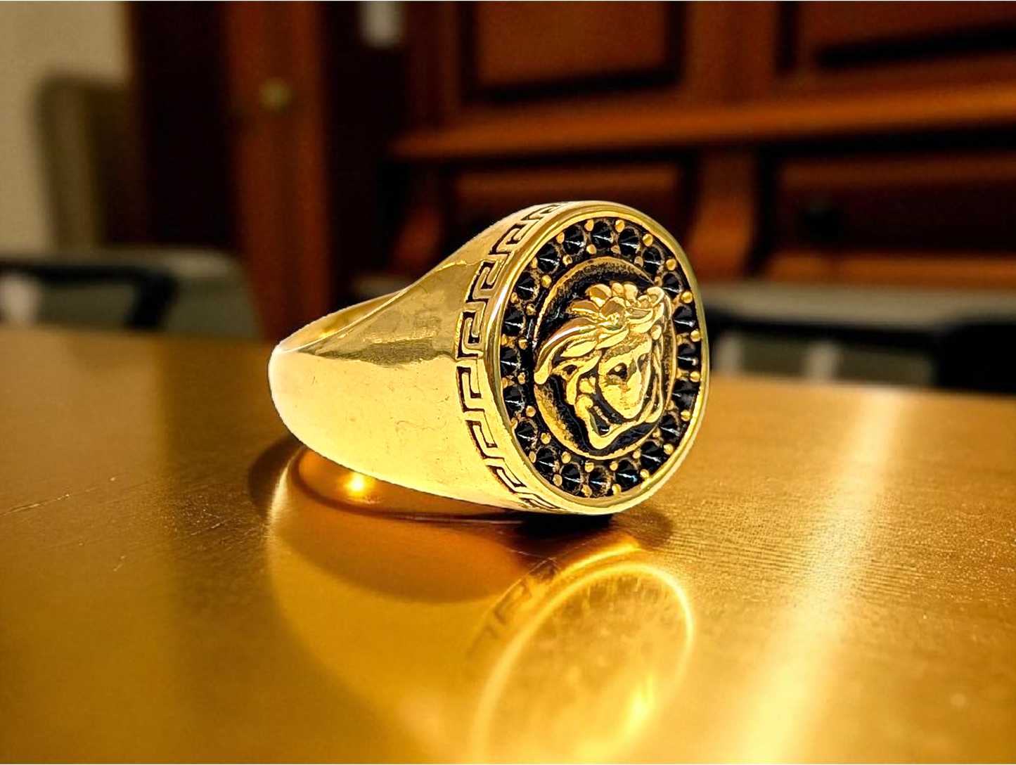 Mythic Elegance: Gold-Tone Ring with Embossed Head & Greek Key Border