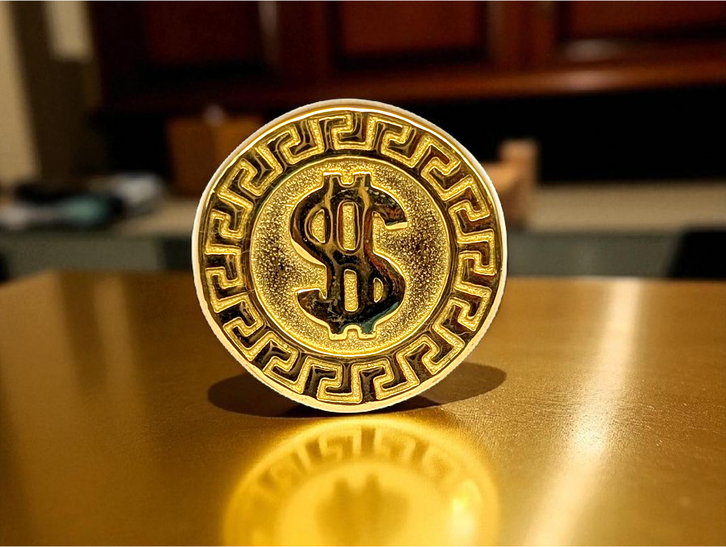 Power & Prestige: Gold-Tone Ring with Embossed Dollar Emblem