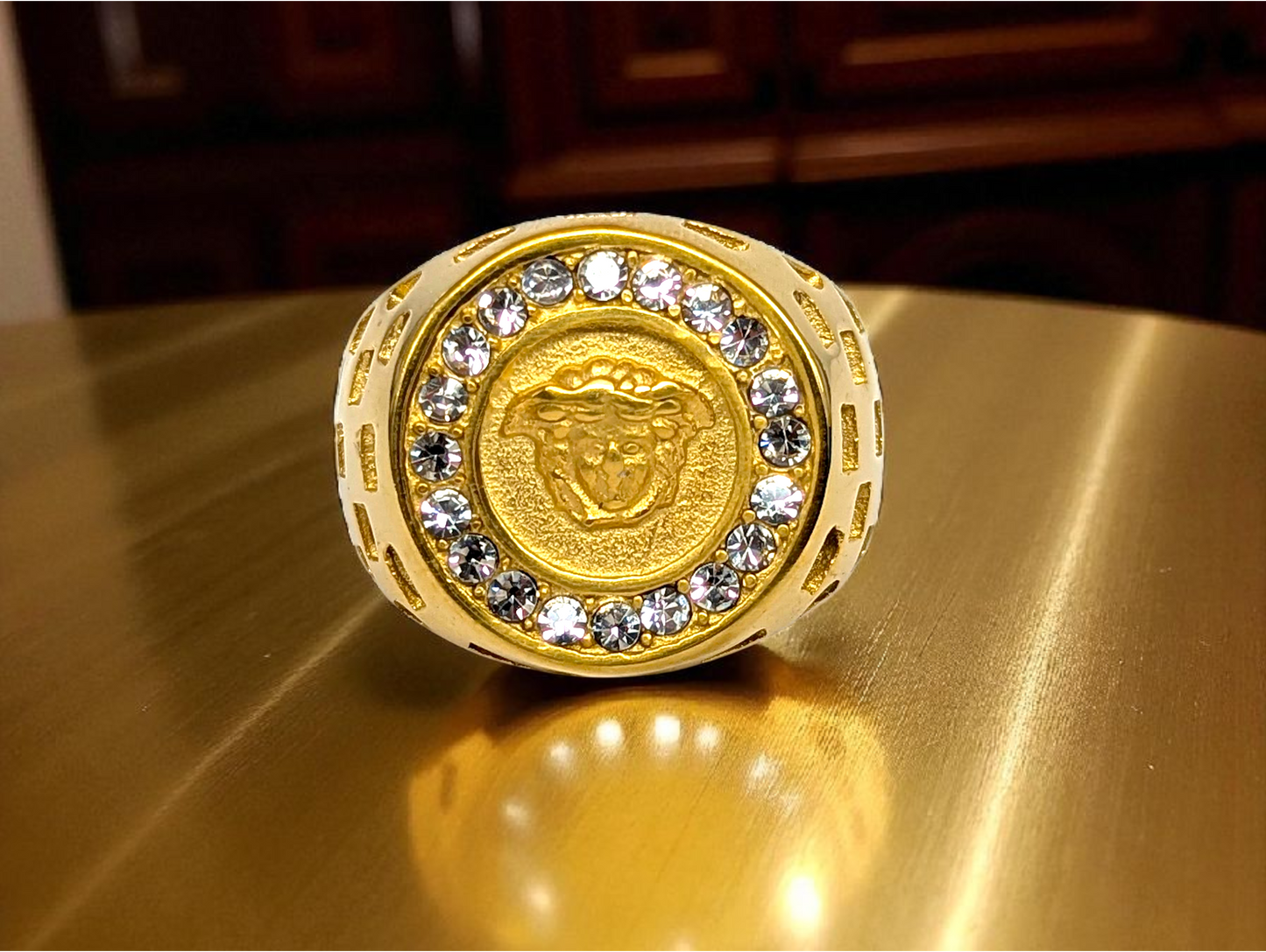 Regal Icon: Gold-Tone Ring with Embossed Head & Gemstone Halo