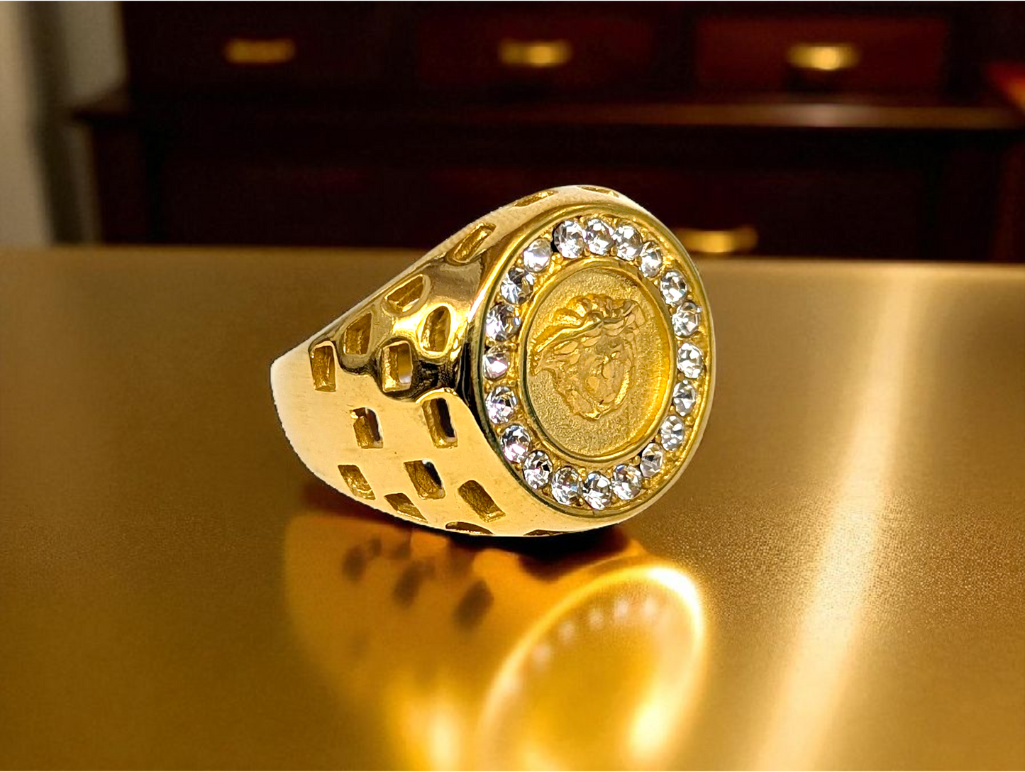 Regal Icon: Gold-Tone Ring with Embossed Head & Gemstone Halo